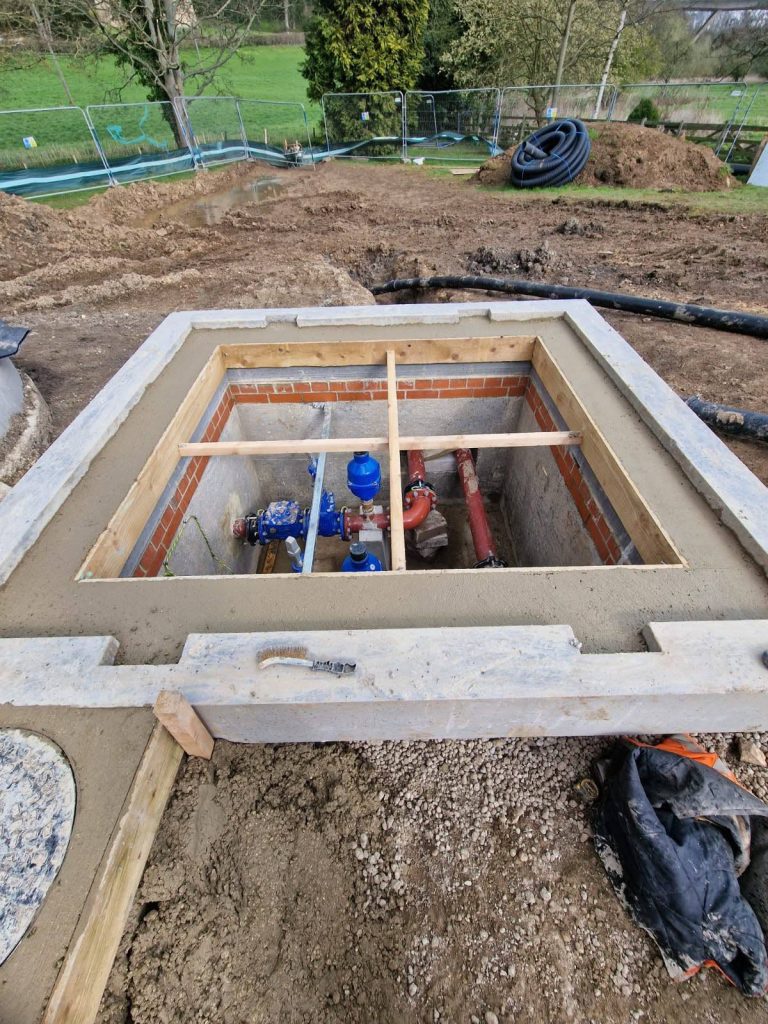 Newly built pump station chamber with valve and pipework connections